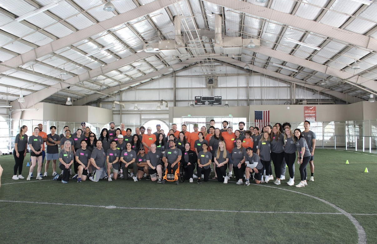 Group photo in indoor sports facility.
